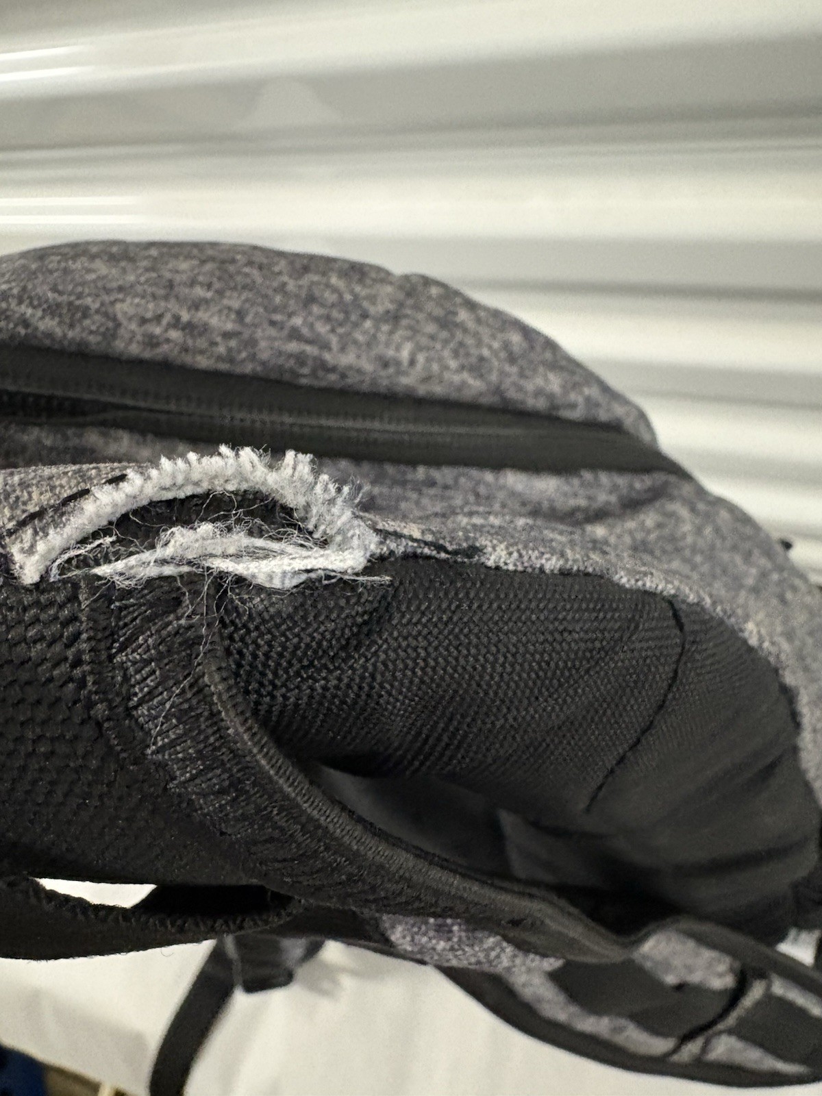 Adidas Defender backpack in grey heather material with black accents.