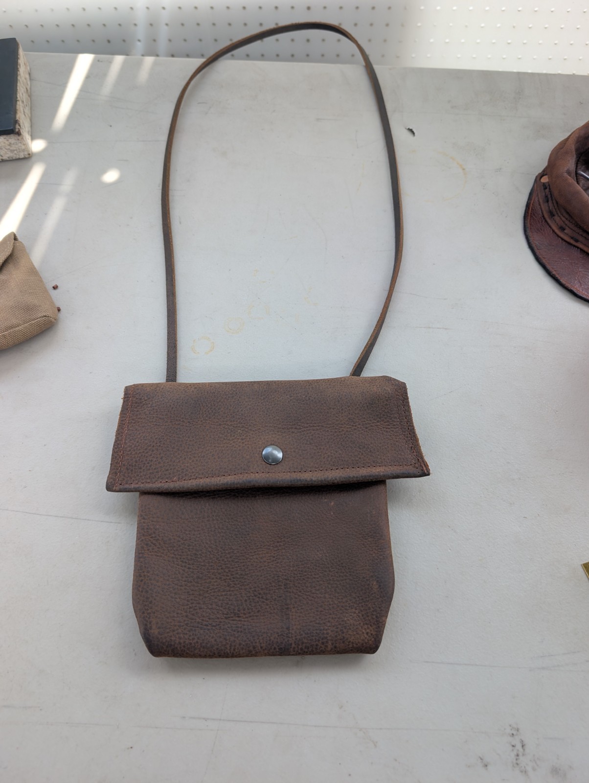 Kodiak cowhide distressed brown leather crossbody bag with button snap