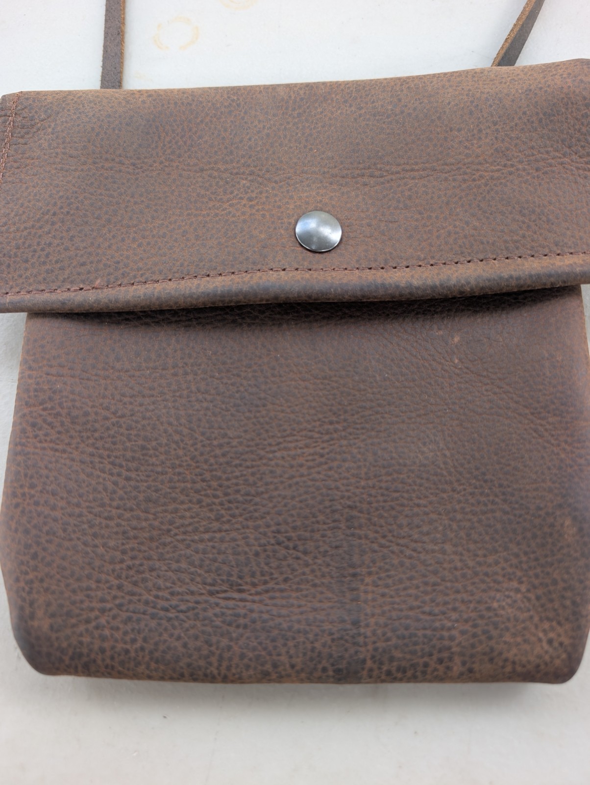 Kodiak cowhide distressed brown leather crossbody bag with button snap
