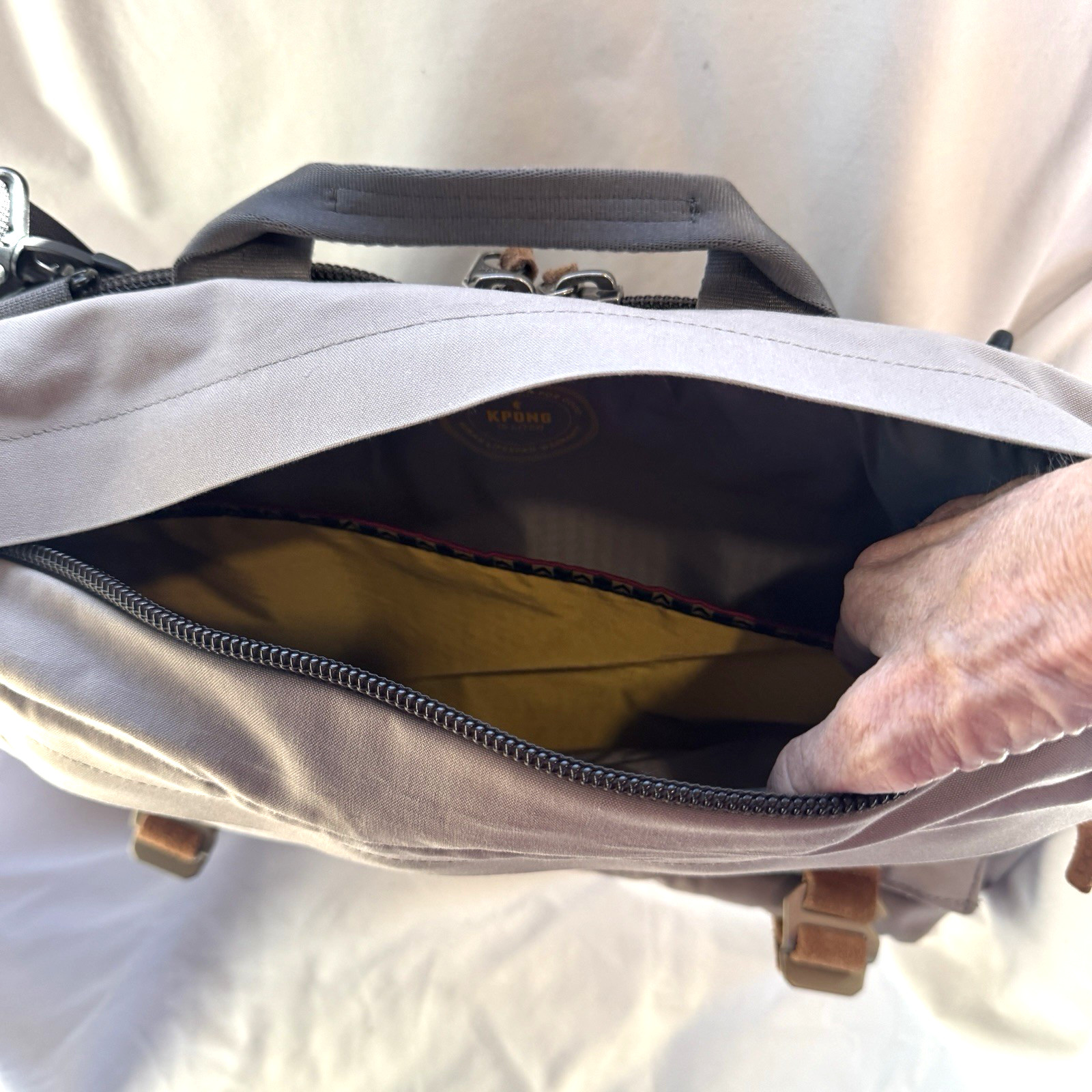 Cotopaxi computer messenger bag. Lots of pockets and company embroidered, Tan