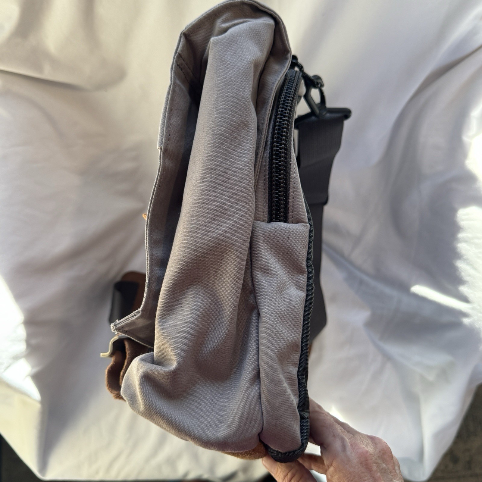 Cotopaxi computer messenger bag. Lots of pockets and company embroidered, Tan