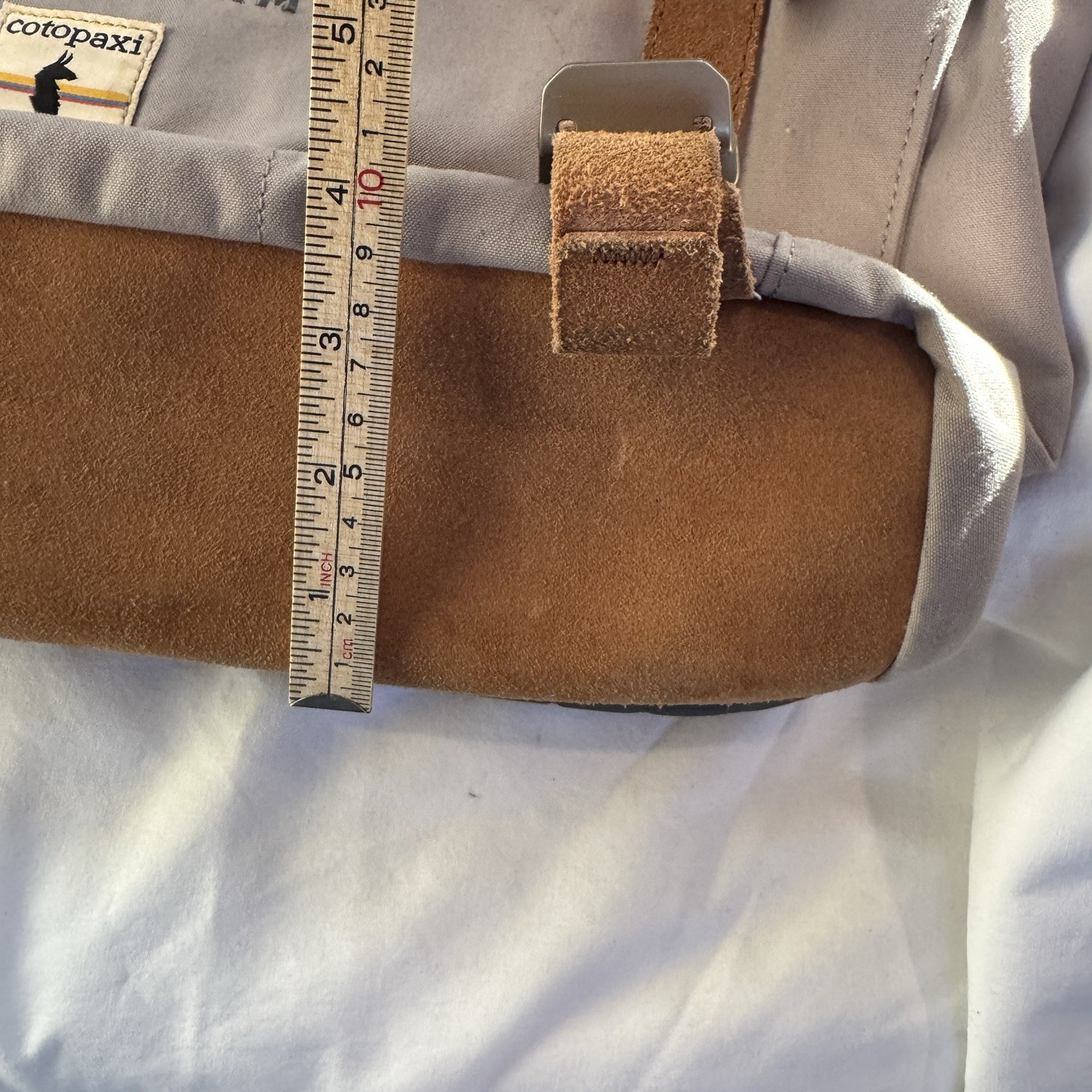 Cotopaxi computer messenger bag. Lots of pockets and company embroidered, Tan