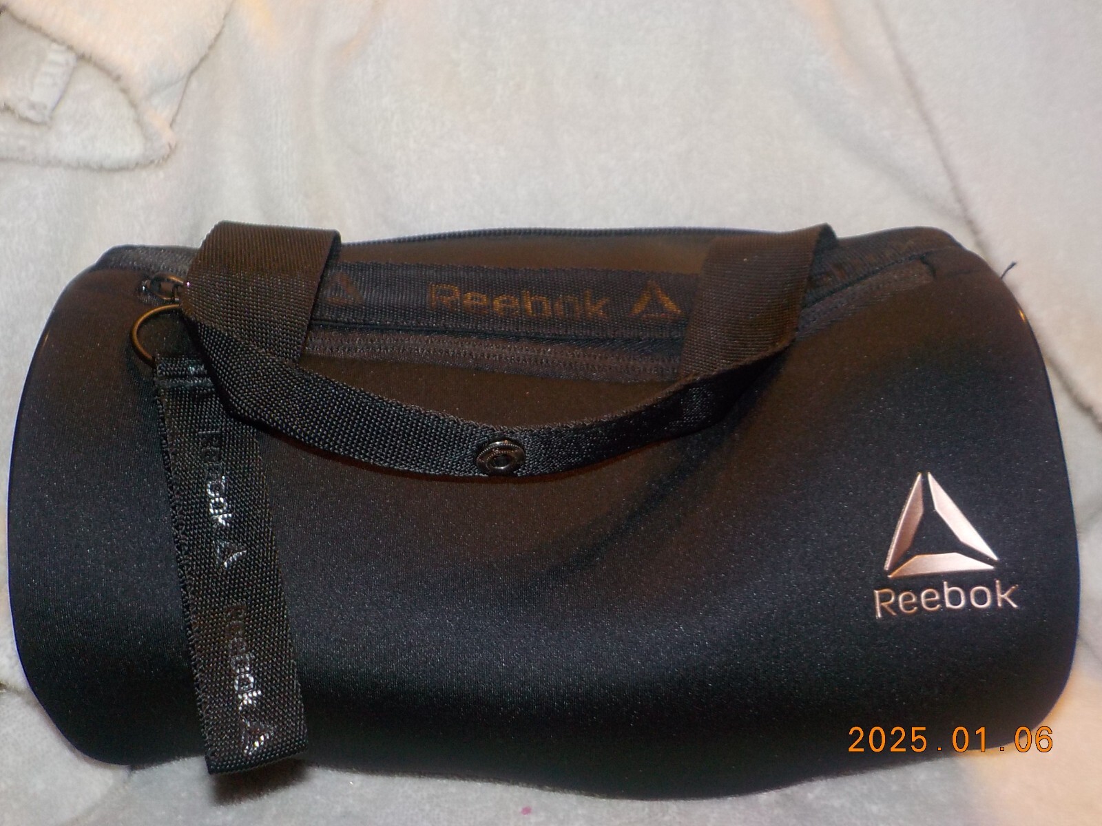 Reebok small black barrel style bag with wrist strap and carry handle