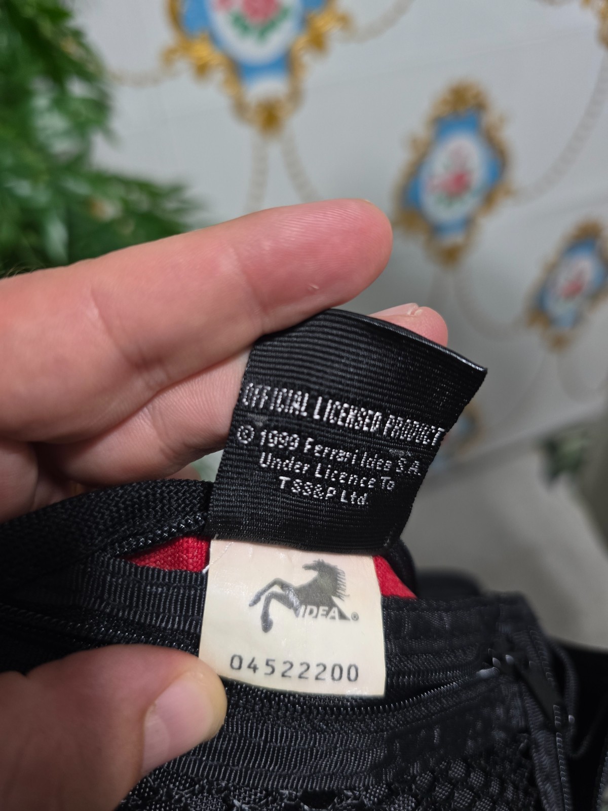 Ferrari branded neck pouch is a red and black canvas bag featuring SCUDERIA LOGO