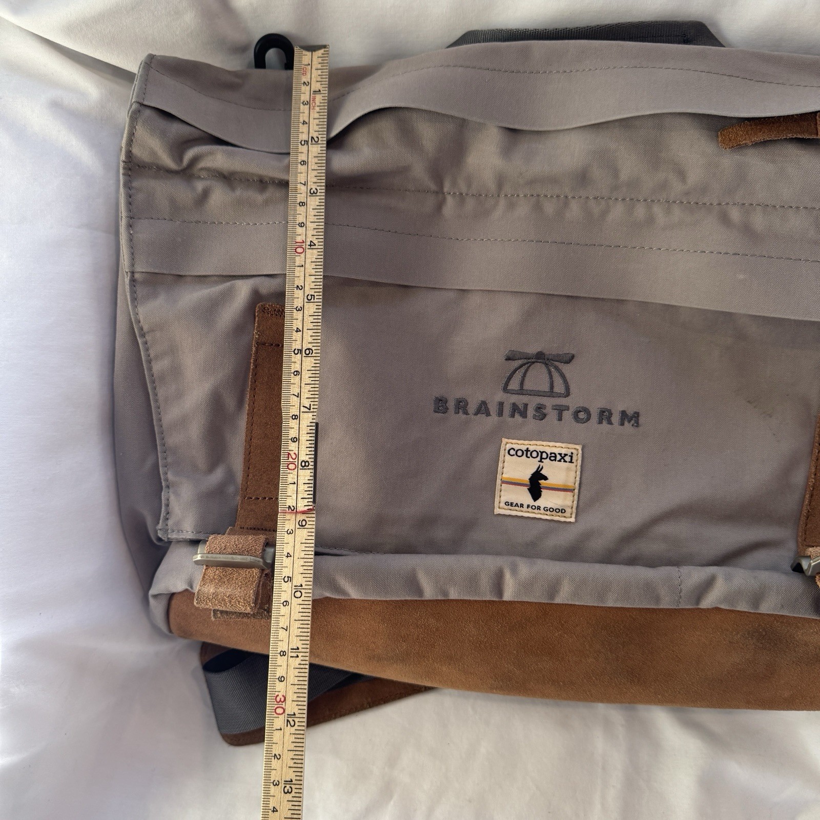 Cotopaxi computer messenger bag. Lots of pockets and company embroidered, Tan