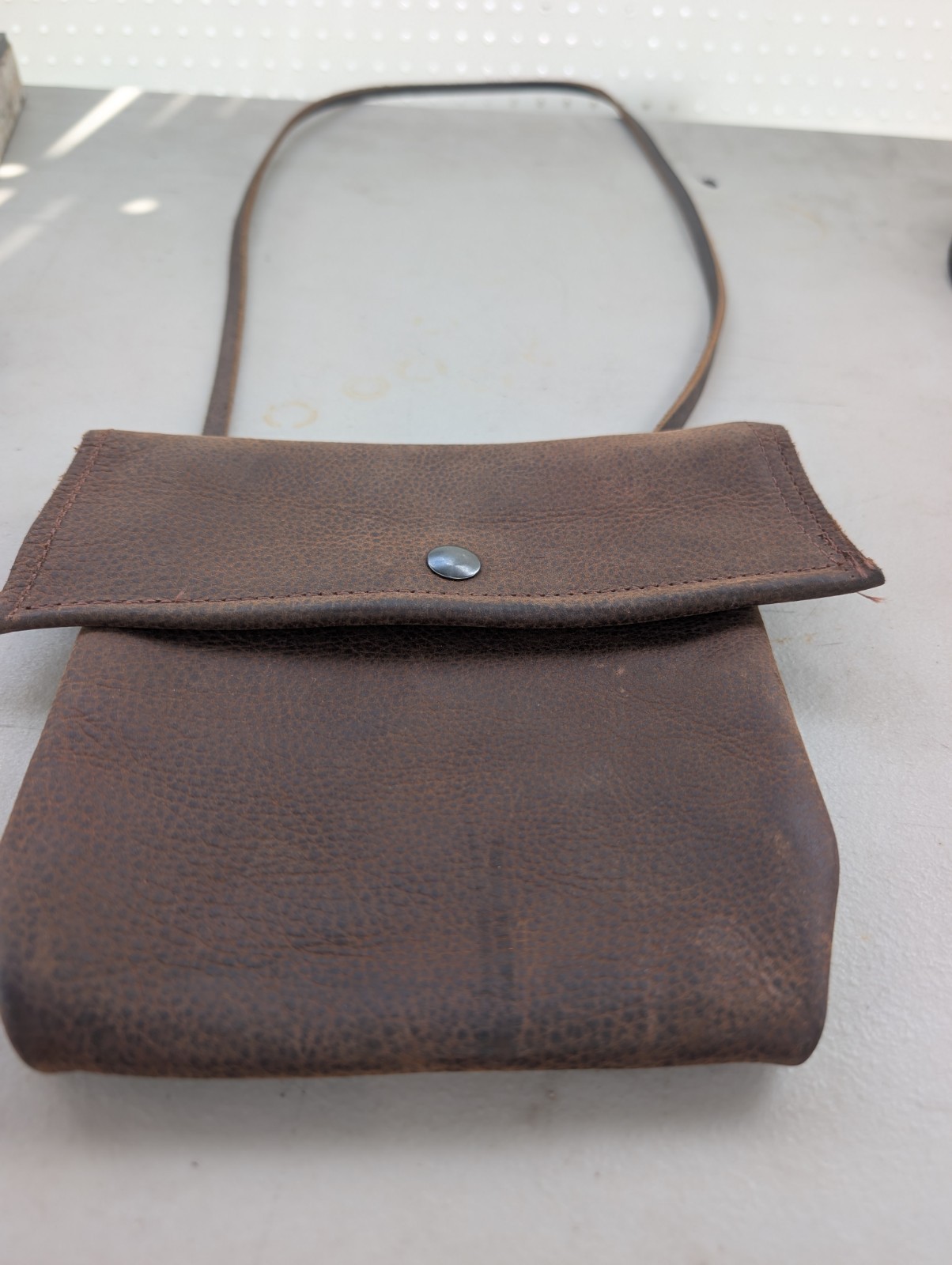 Kodiak cowhide distressed brown leather crossbody bag with button snap