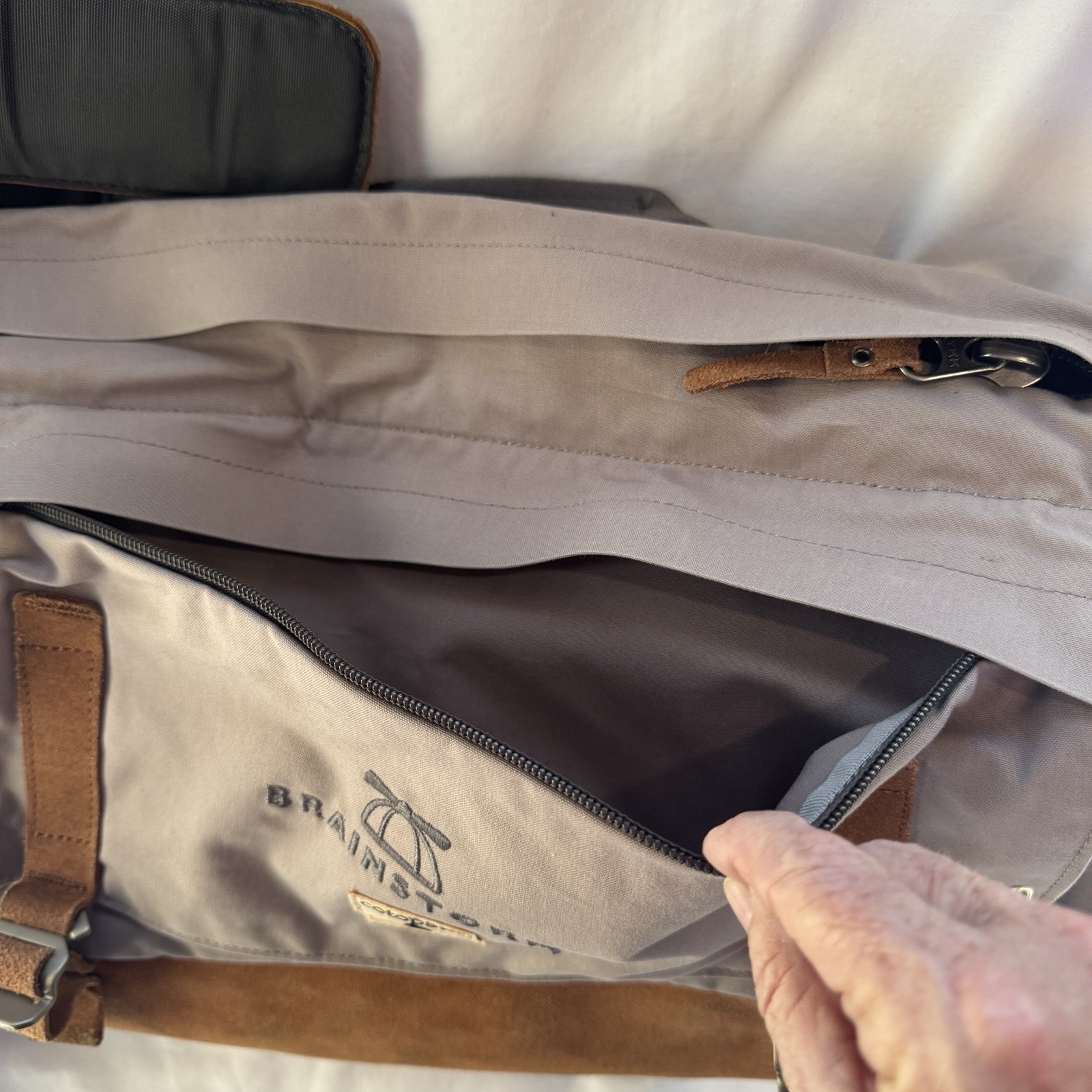 Cotopaxi computer messenger bag. Lots of pockets and company embroidered, Tan