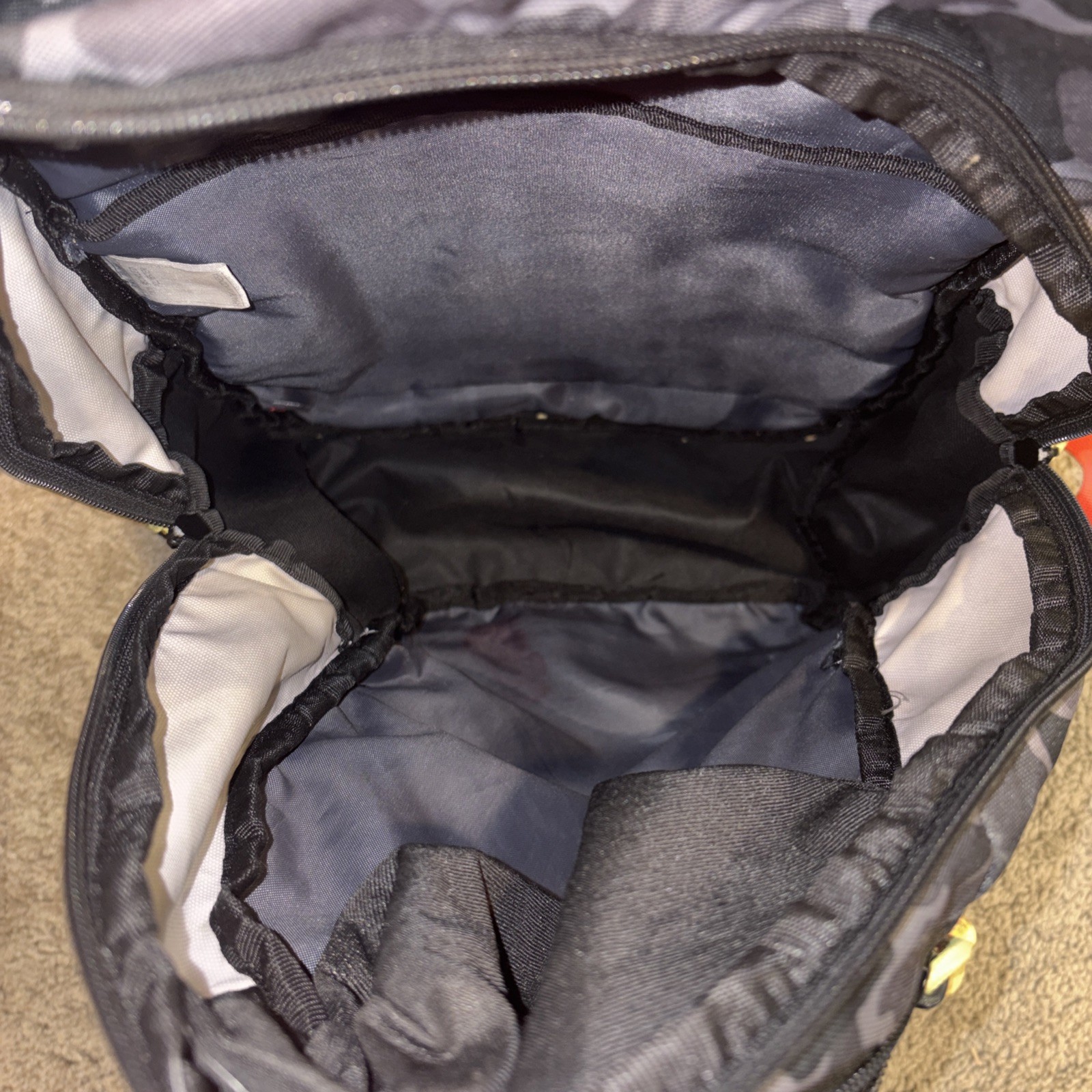 An Adidas Backpack Black Gray Camo. Yellow lettering. Adjustable Red Straps