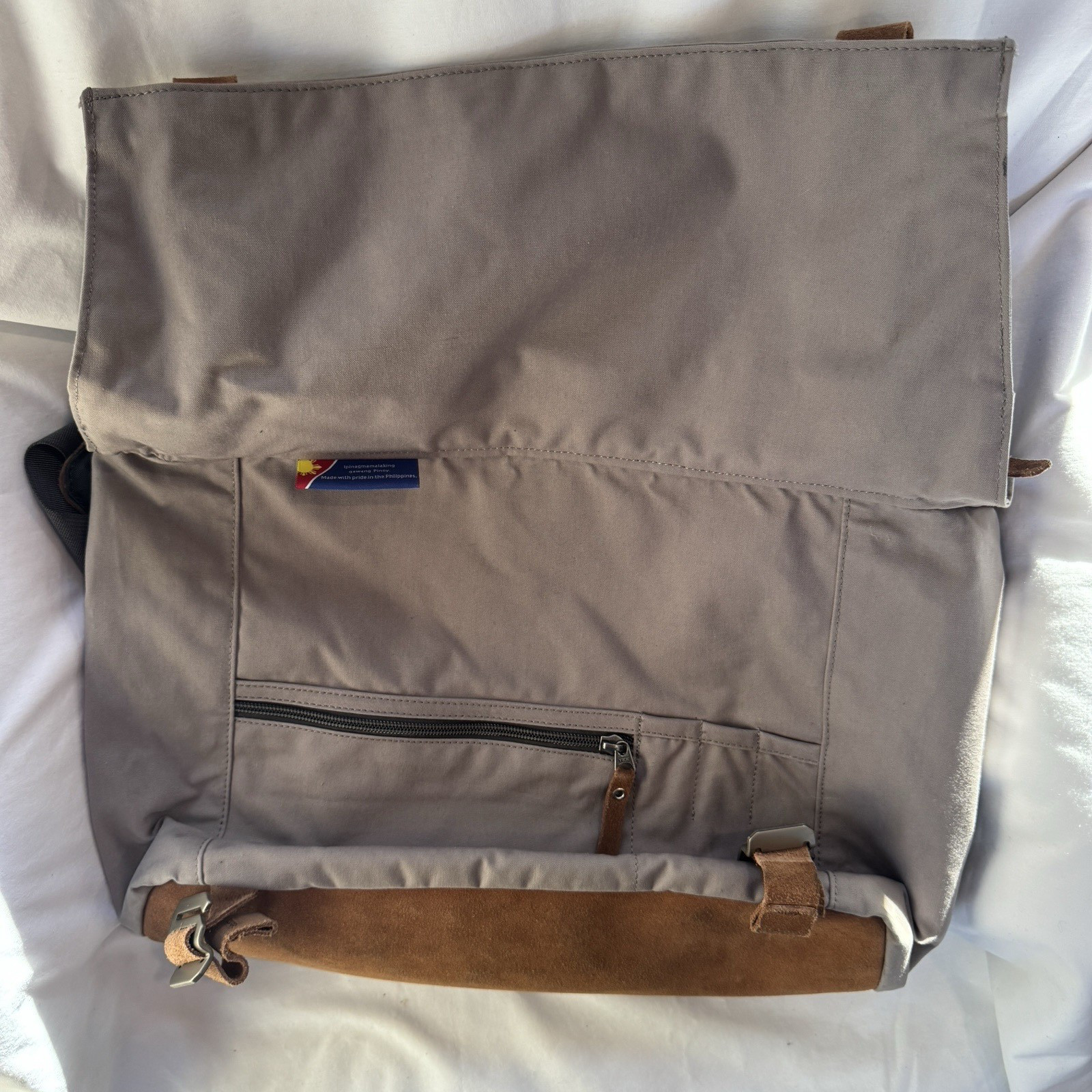 Cotopaxi computer messenger bag. Lots of pockets and company embroidered, Tan