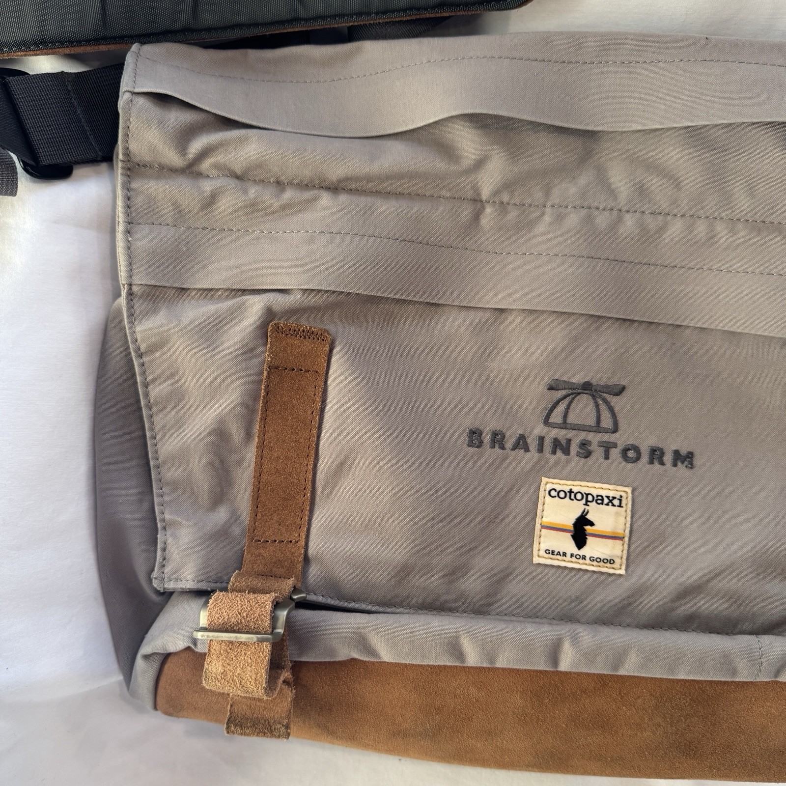 Cotopaxi computer messenger bag. Lots of pockets and company embroidered, Tan