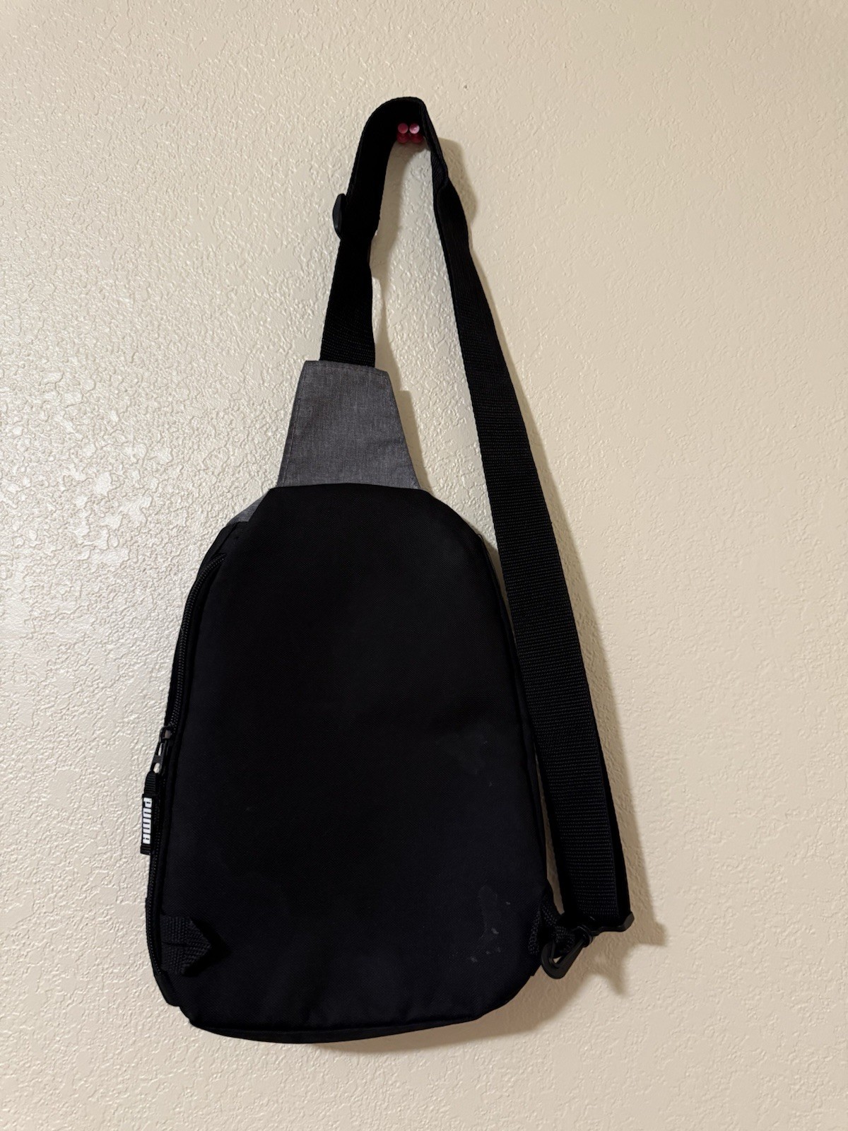 Puma Evercat Sidewall Sling Backpack in black and heather grey.