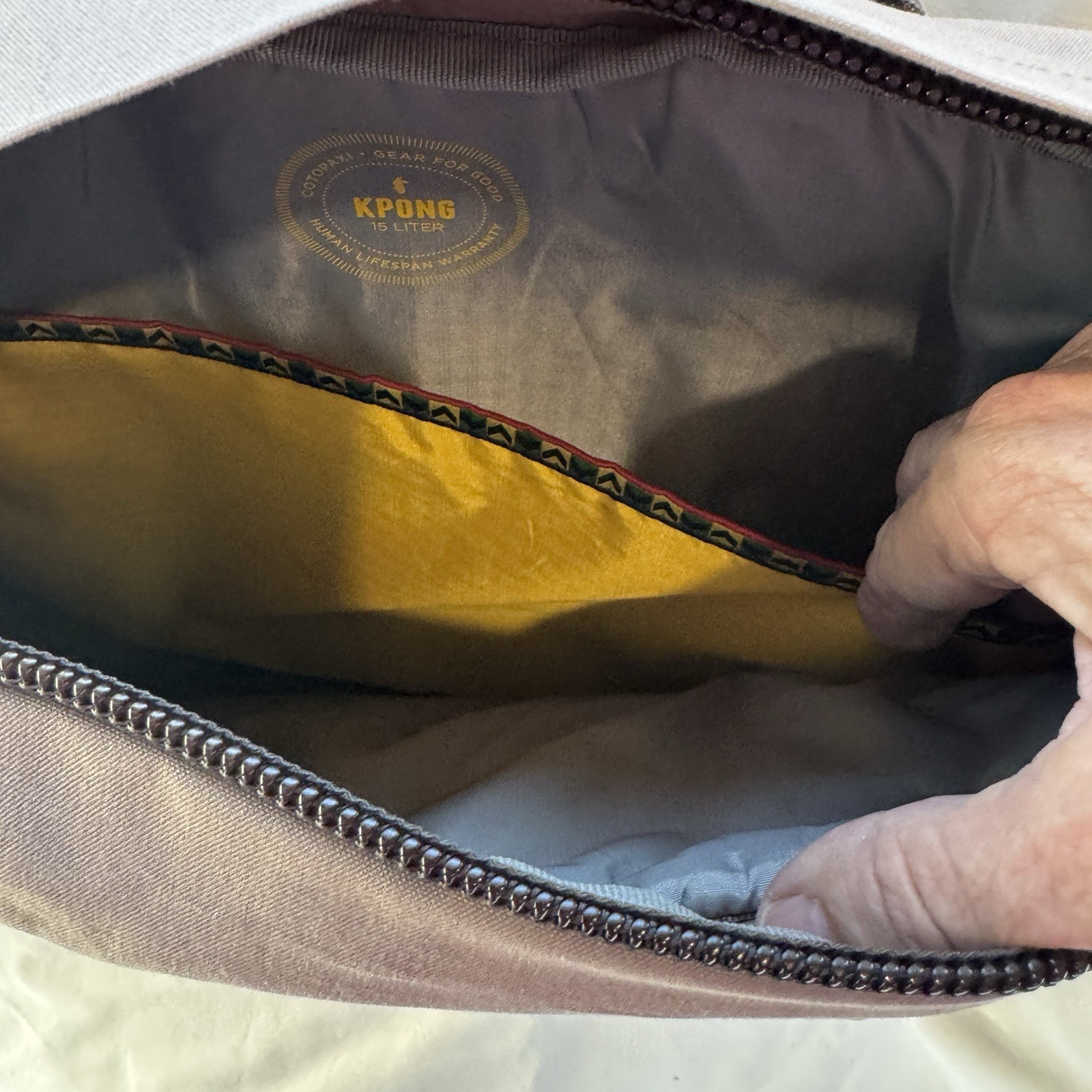 Cotopaxi computer messenger bag. Lots of pockets and company embroidered, Tan