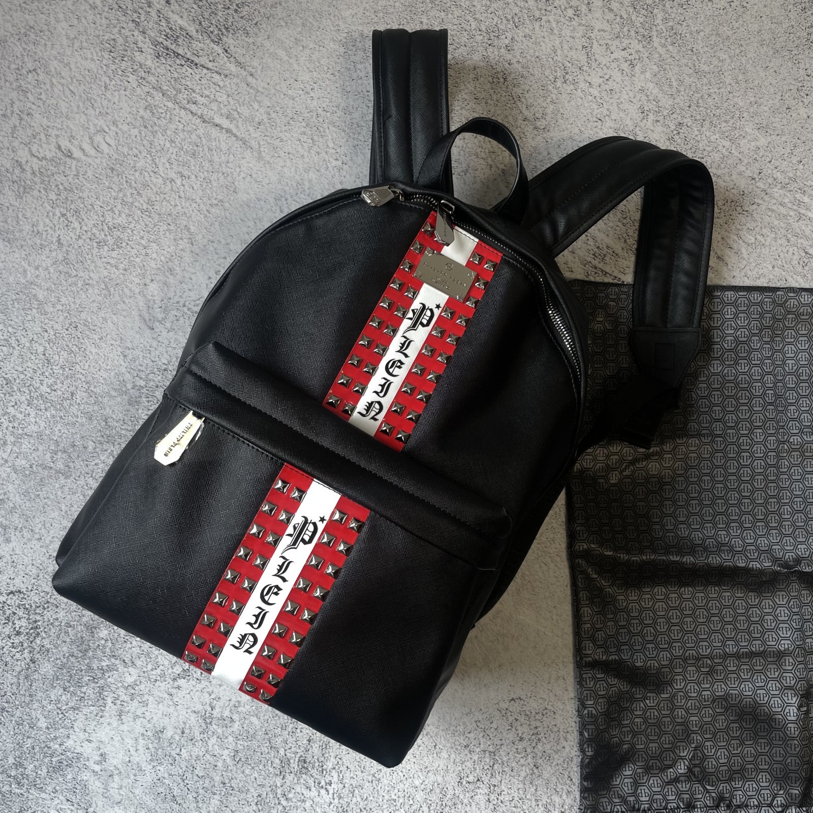 Philipp Plein black backpack, spikes, red center stripe, luxury streetwear SS26.