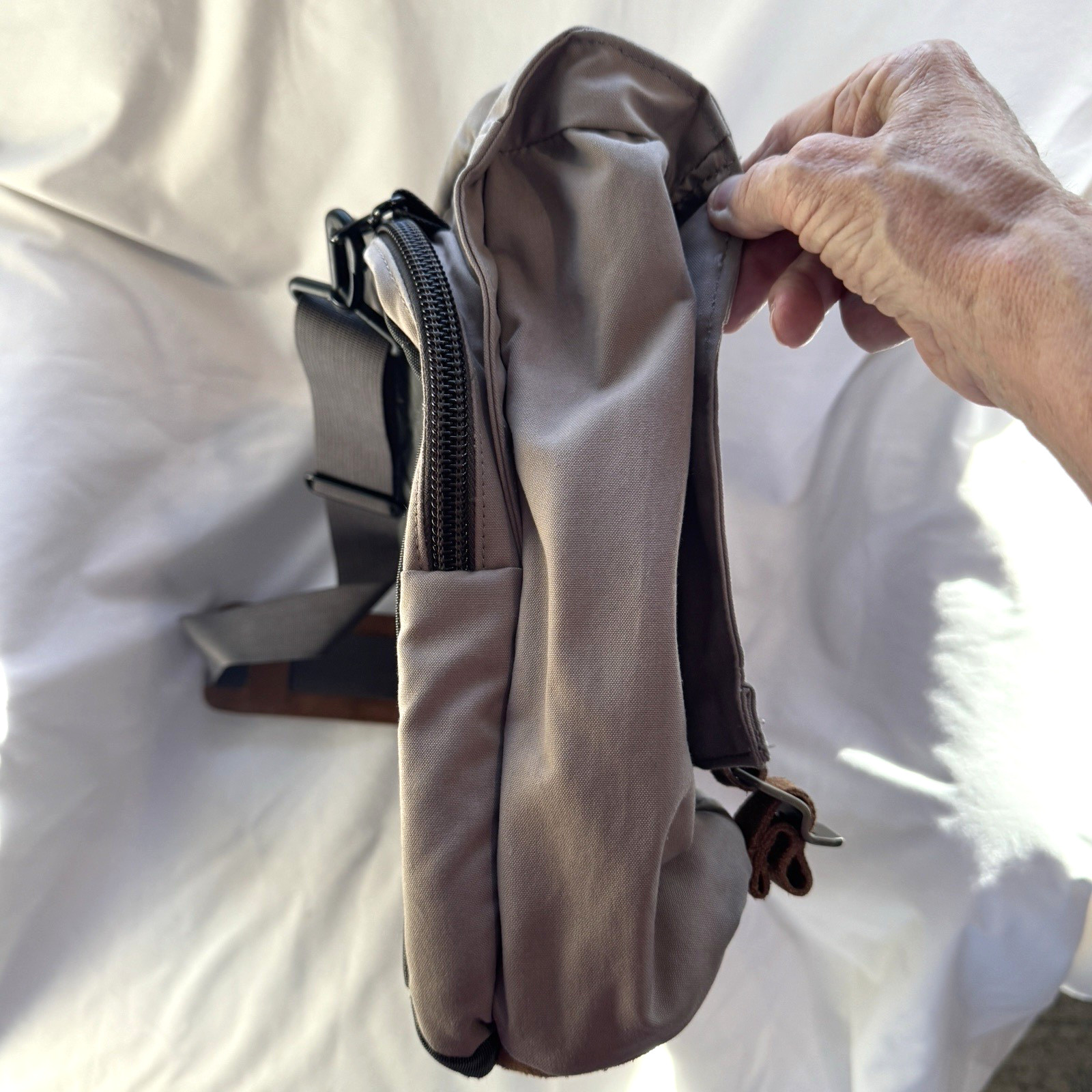 Cotopaxi computer messenger bag. Lots of pockets and company embroidered, Tan