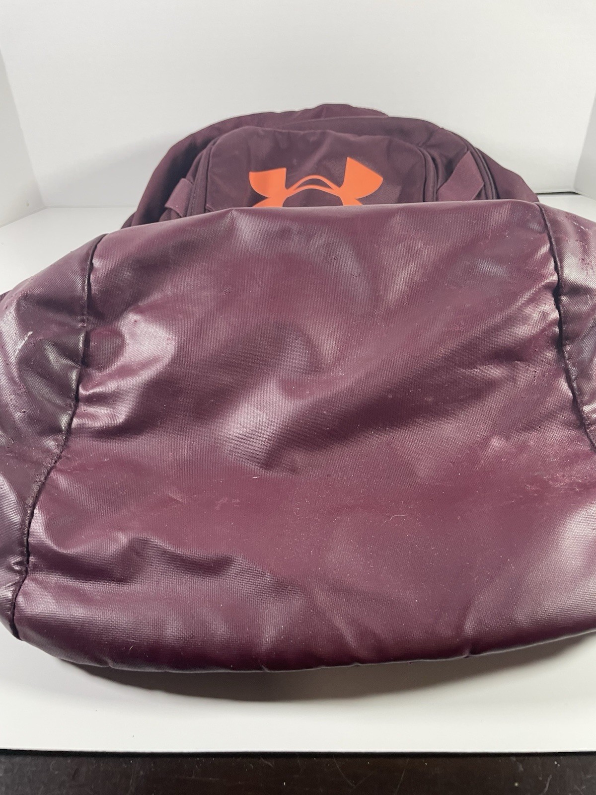 Under Armour Hustle 3.0 Backpack in the Dark Maroon and Orange colorway.