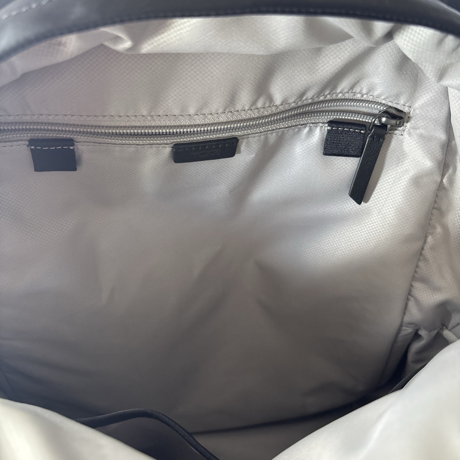 TUMI Black Backpack, Zip Closure, Adjustable Straps, Pockets, Top Handle