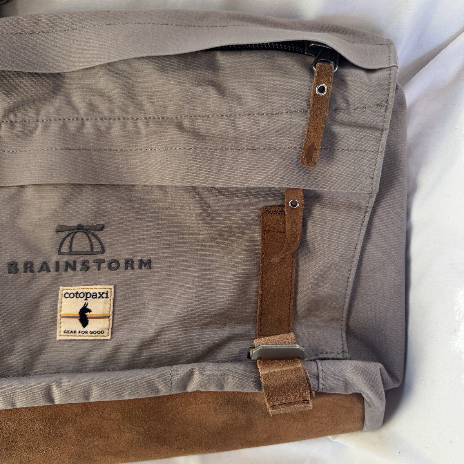 Cotopaxi computer messenger bag. Lots of pockets and company embroidered, Tan