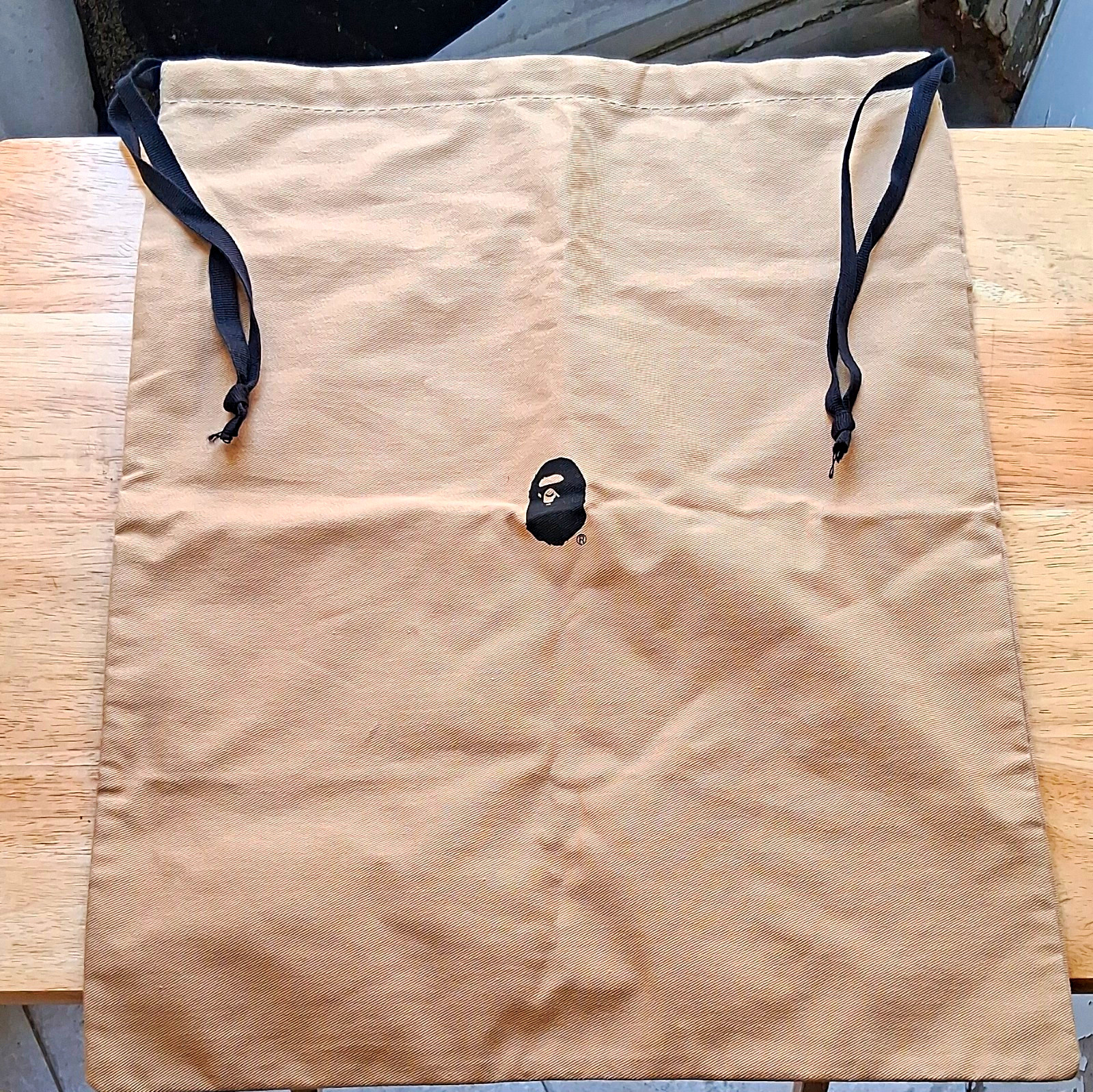 A Bathing Ape BAPE Beige & Black Ape Head Logo Solid Drawstring Bag