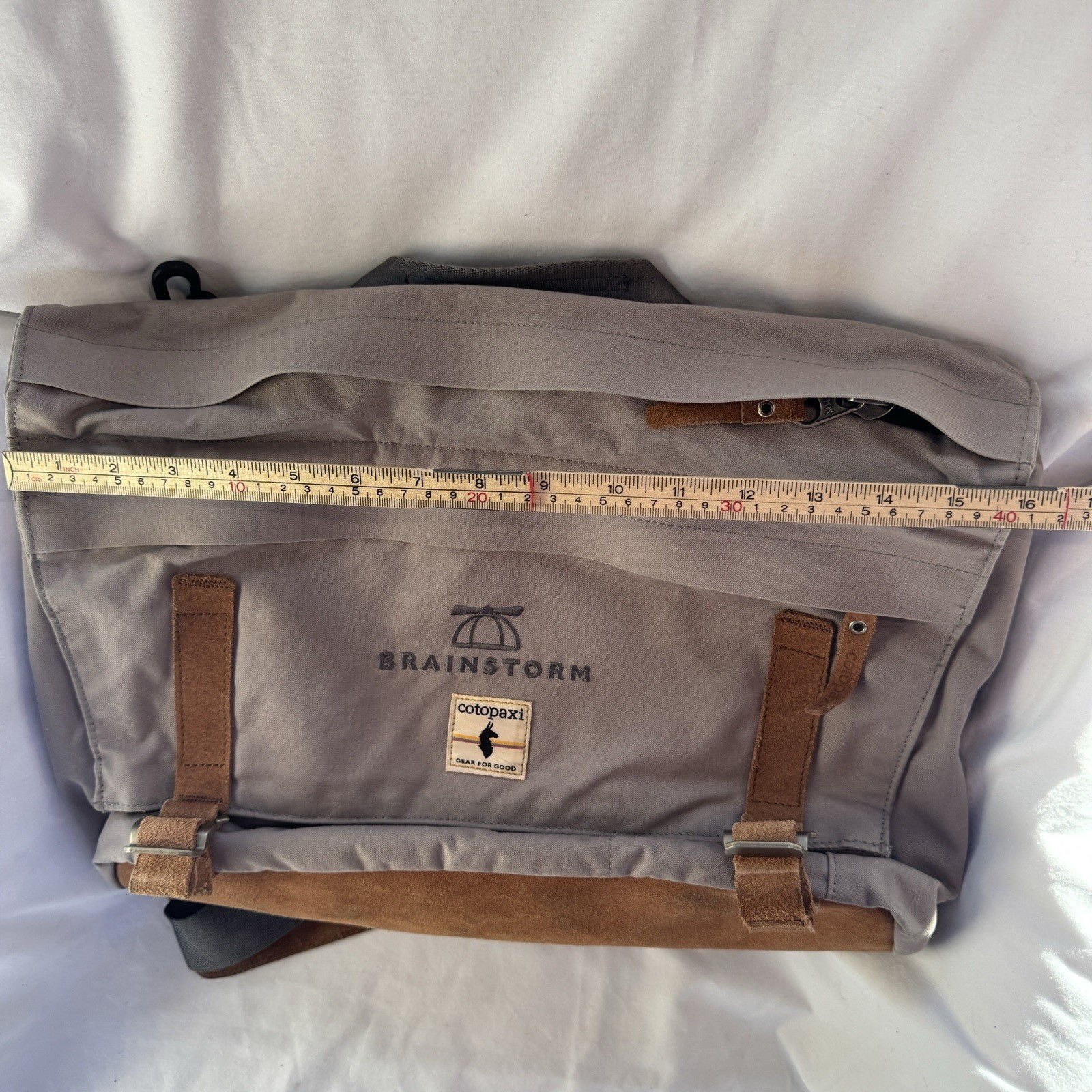 Cotopaxi computer messenger bag. Lots of pockets and company embroidered, Tan