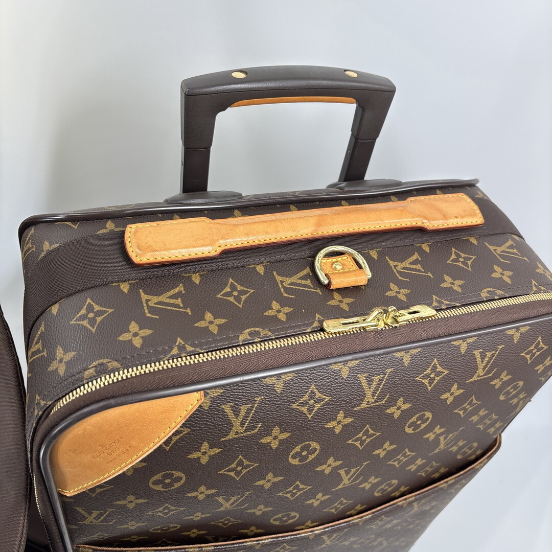 Louis Vuitton M23294 Monogram Pegase 55 carry-on suitcase in brown.