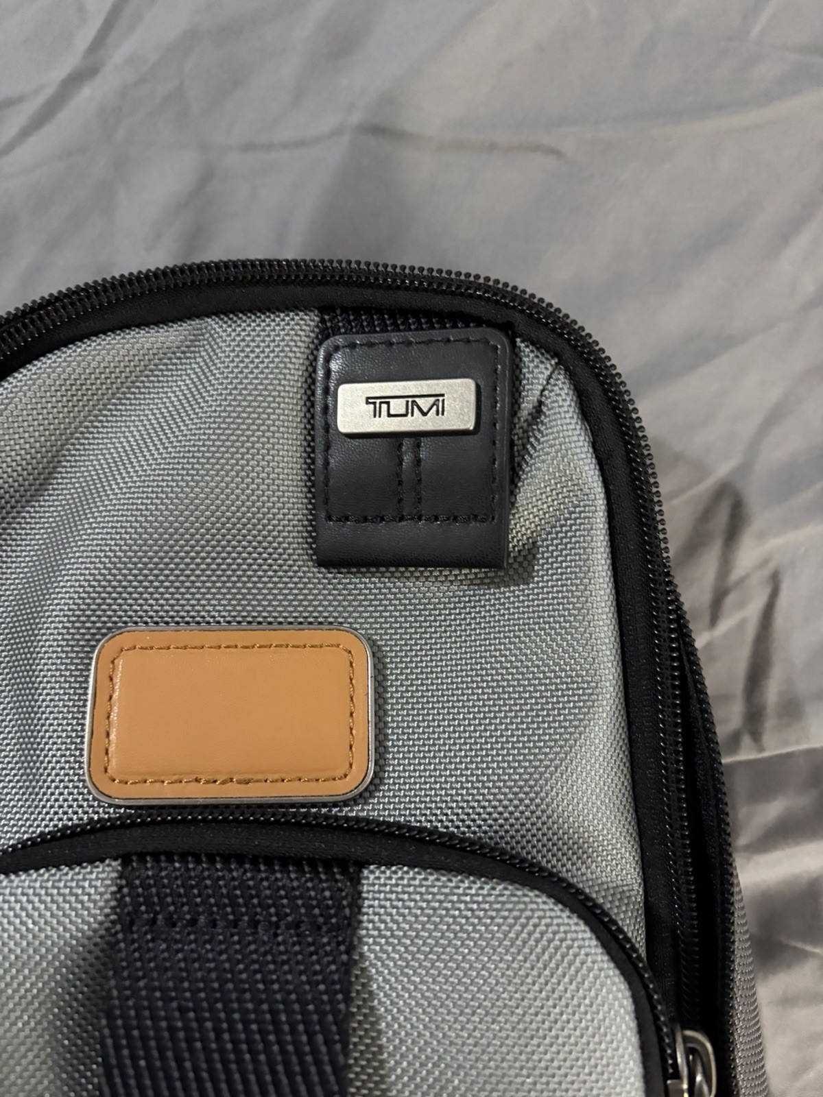 Tumi Gray/Black Small Crossbody Sling Bag Zip Closure, Adjustable Strap, Pockets