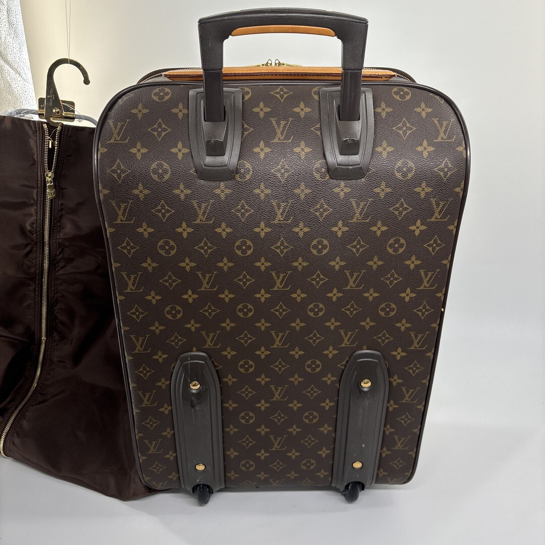 Louis Vuitton M23294 Monogram Pegase 55 carry-on suitcase in brown.