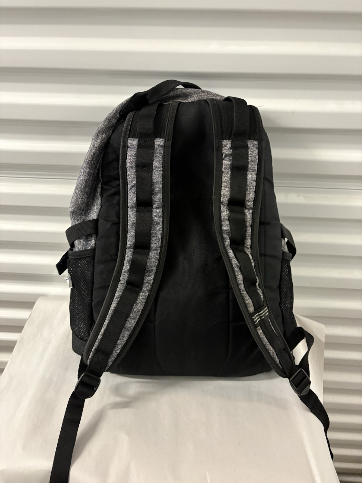 Adidas Defender backpack in grey heather material with black accents.