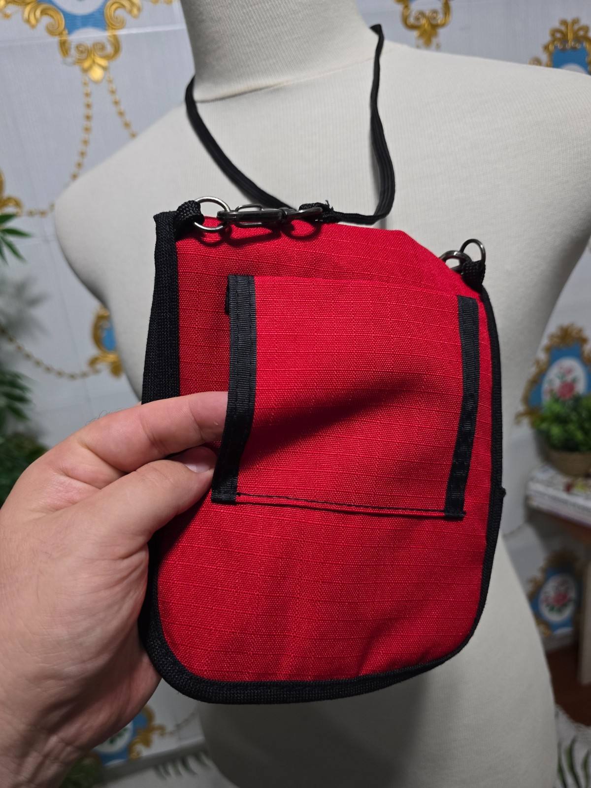 Ferrari branded neck pouch is a red and black canvas bag featuring SCUDERIA LOGO